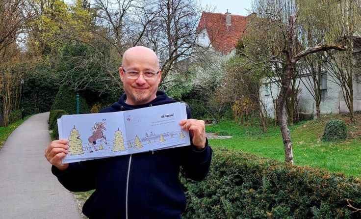 Illustrator Helmut "Dino" Breneis mit dem neuen Buch. (Foto: Tips)