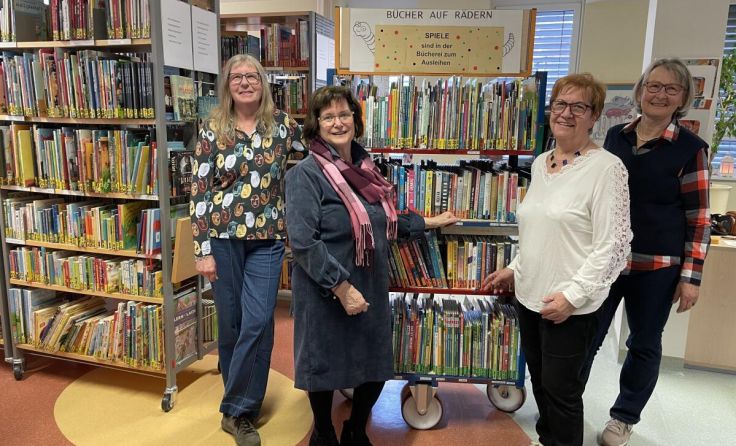 Ehrenamtliche Mitarbeiterinnen mit dem Bücherwagen (Foto: KUK)