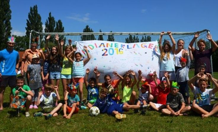 Die Kids und ihre Betreuer mit ihrem selbst gestalteten Plakat Foto: mai