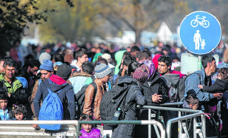 Flüchtlinge warten bei Passau auf die Einreise nach Deutschland. Foto: Vowe