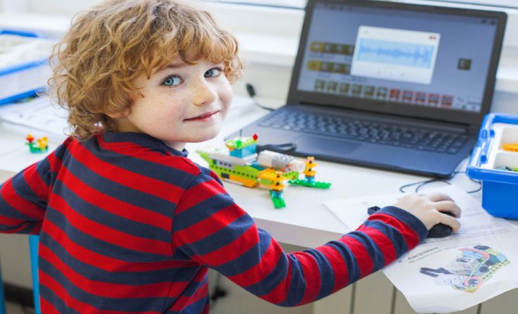 Kind programmiert Roboter Foto: Shutterstock.com/Elena Sherengovskaya