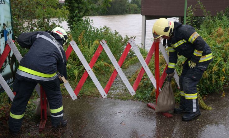 Feuerwehrleute sichern das Traunufer in Wels. (Foto: laumat/Matthias Lauber)